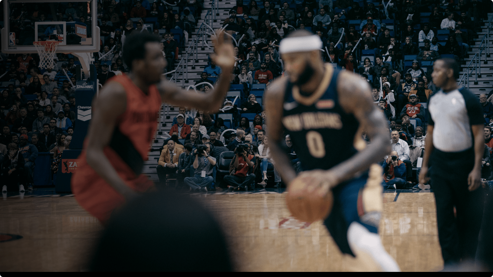 Live basketball game with packed arena crowd
